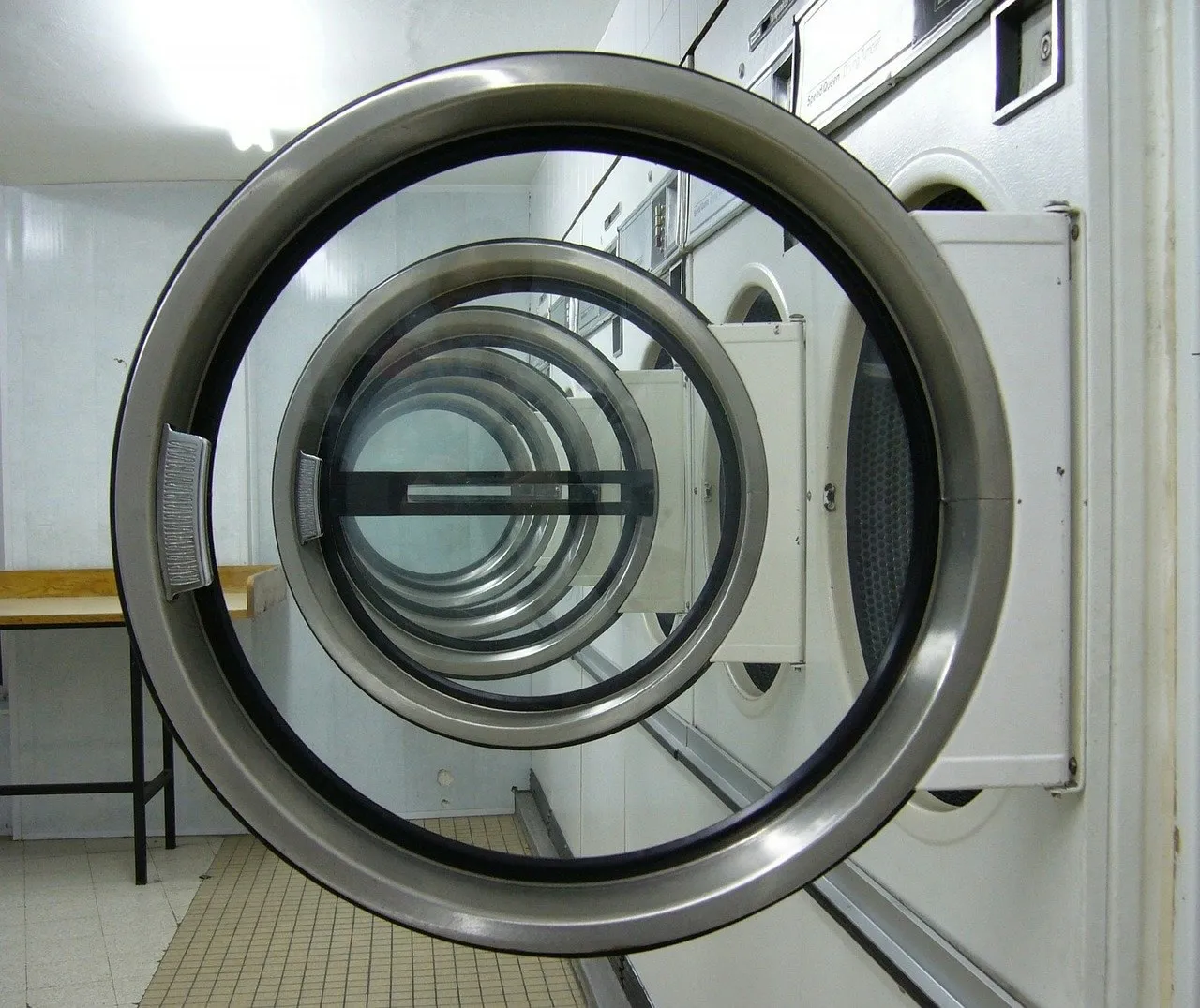 The open door of a stainless steel front-loading washing machine